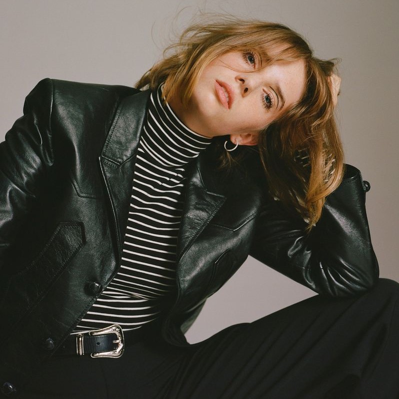 Photo of Maya Hawke in a leather jacket looking to the right